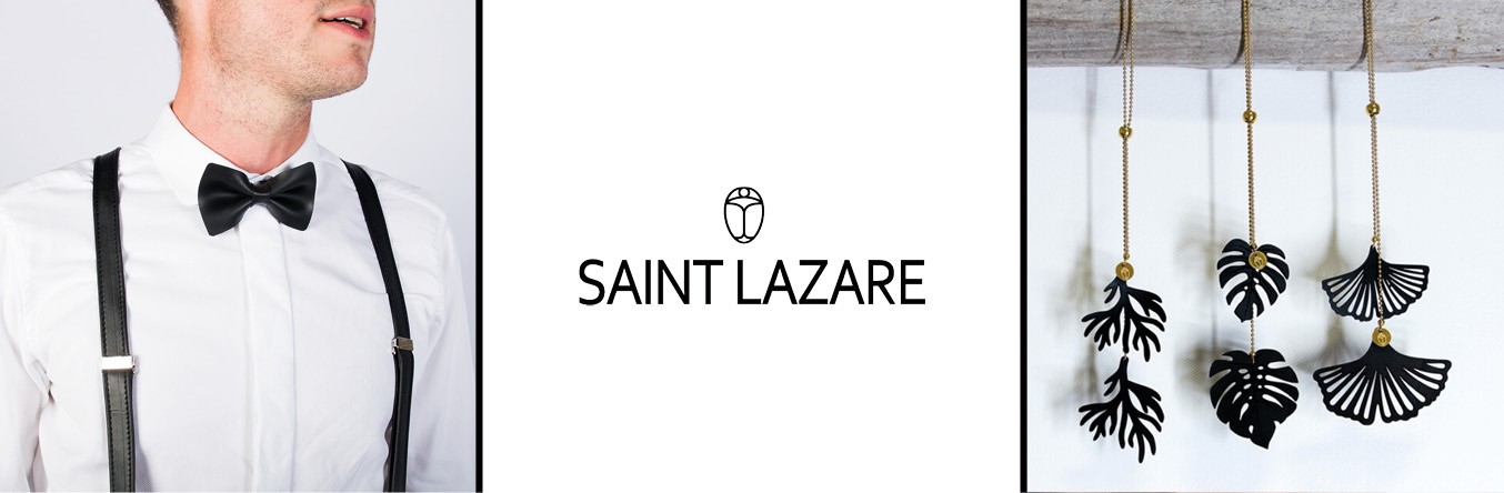 Noeud papillon porté et boucles d'oreilles noirs sur support avec logo de la marque Saint Lazare